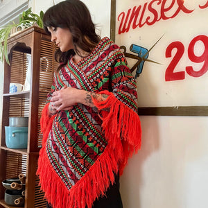 Bright colorful poncho with fringe