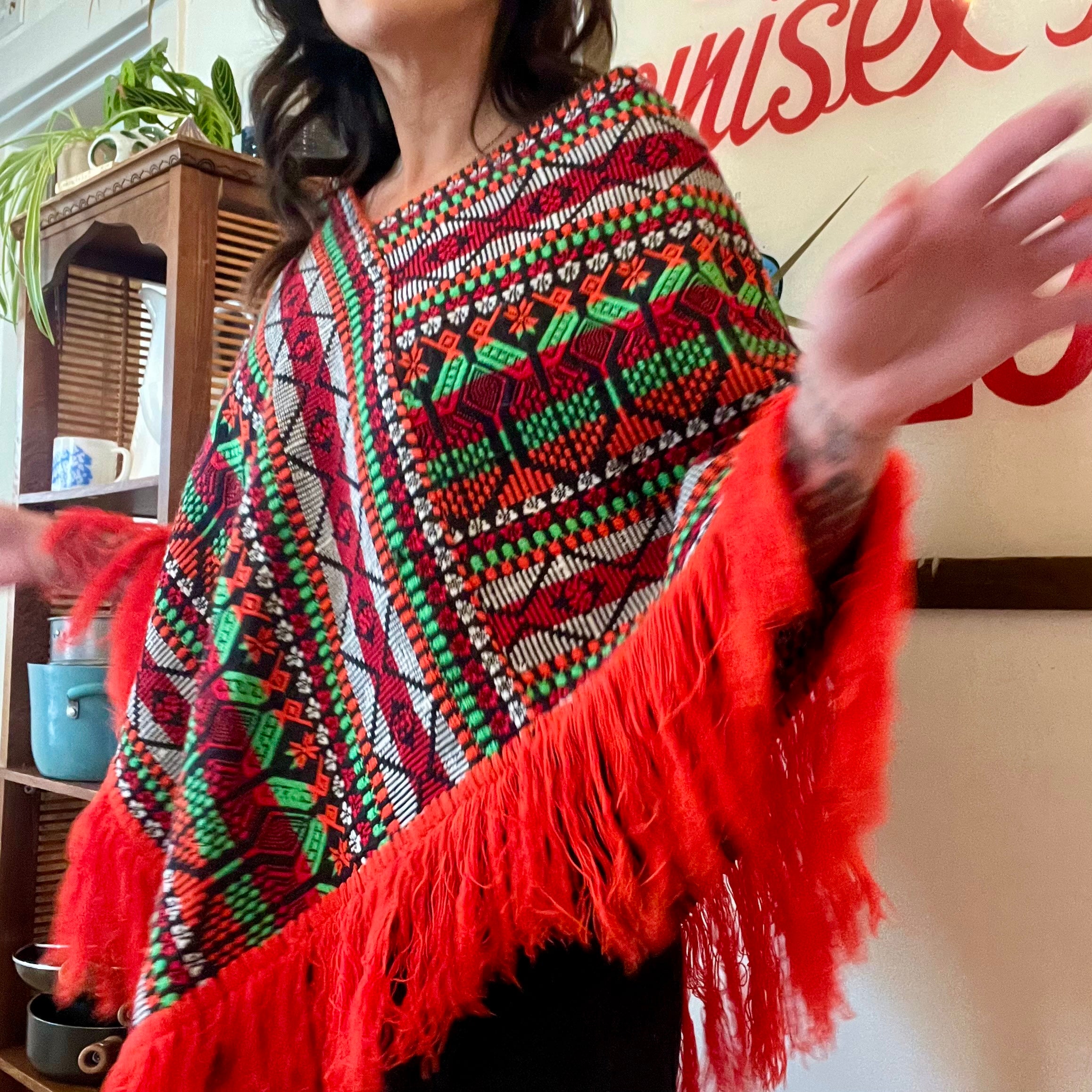 Bright colorful poncho with fringe