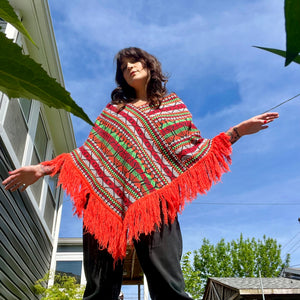 Bright colorful poncho with fringe