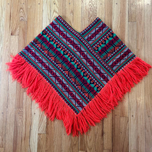 Bright colorful poncho with fringe