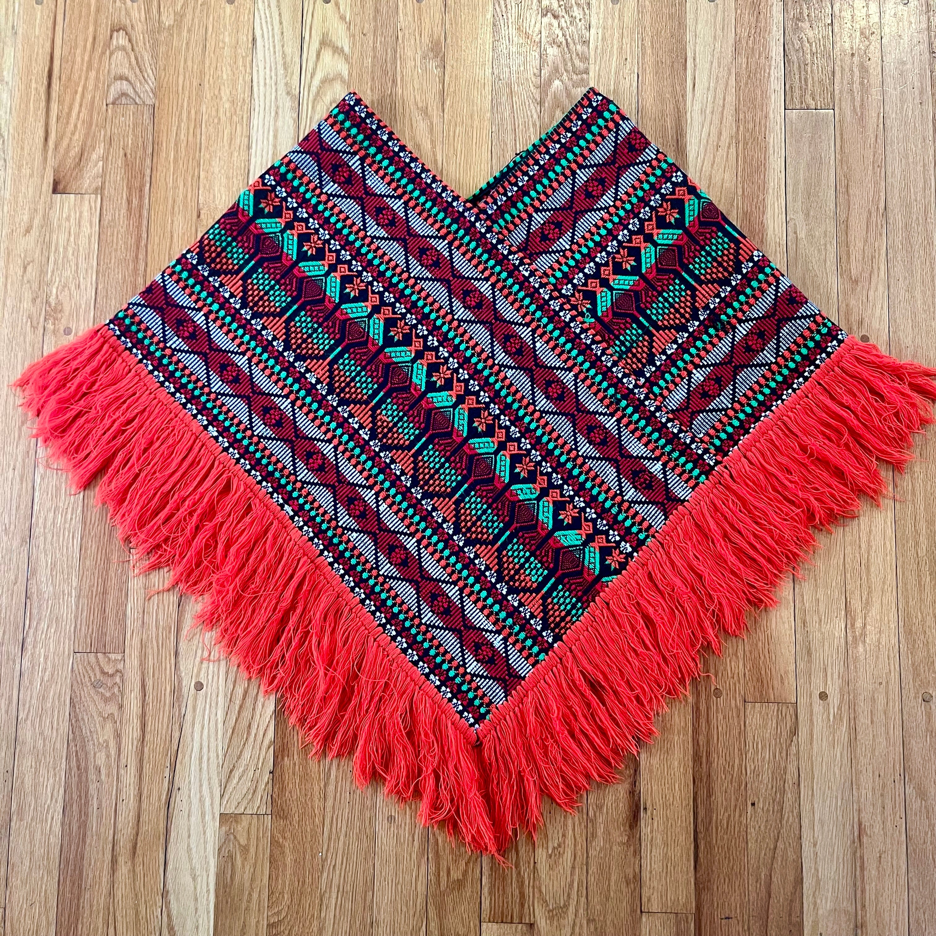 Bright colorful poncho with fringe