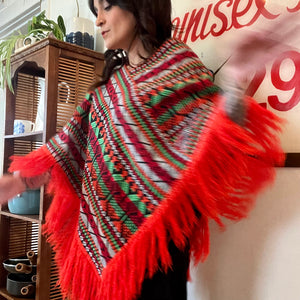 Bright colorful poncho with fringe