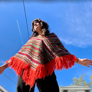 Bright colorful poncho with fringe