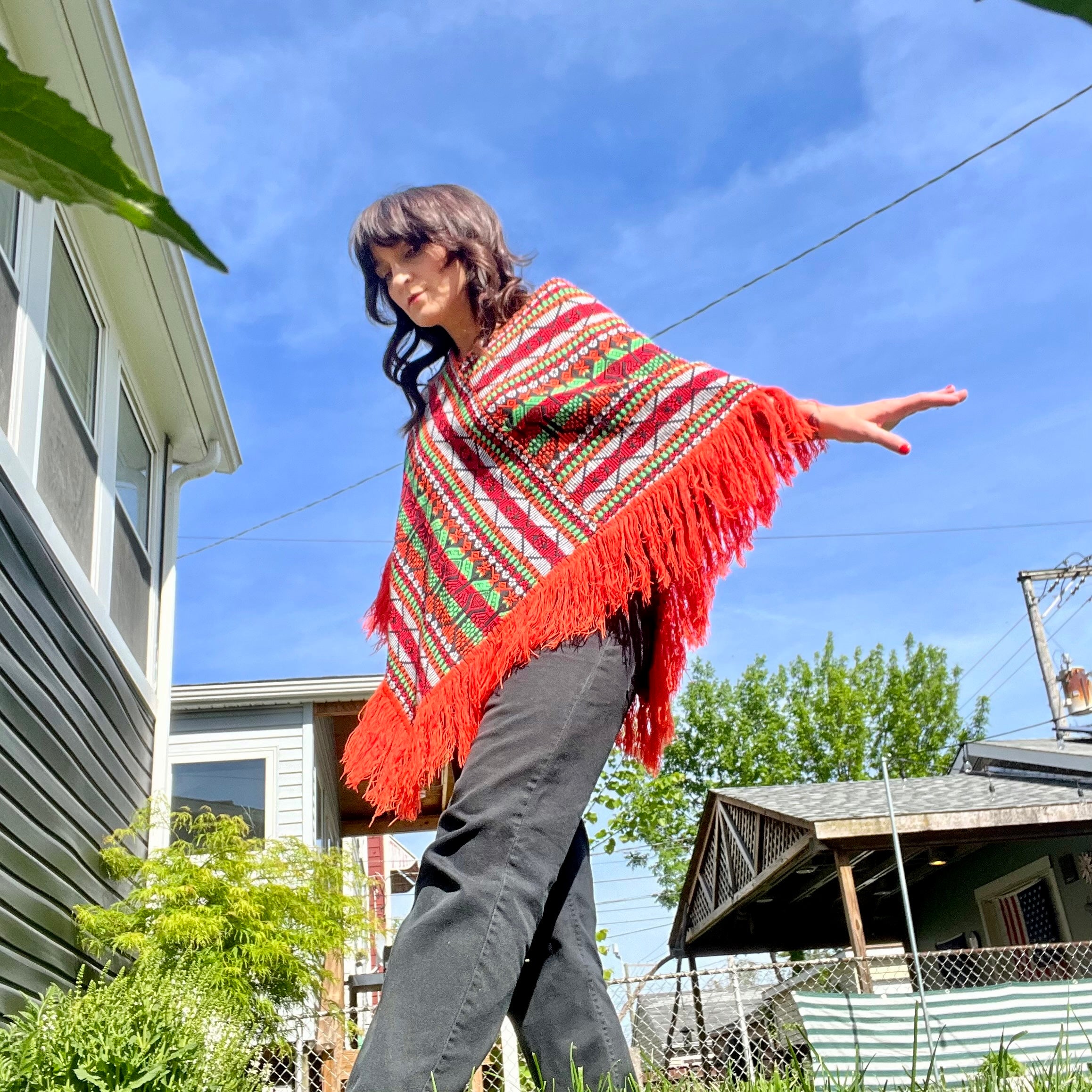 Bright colorful poncho with fringe