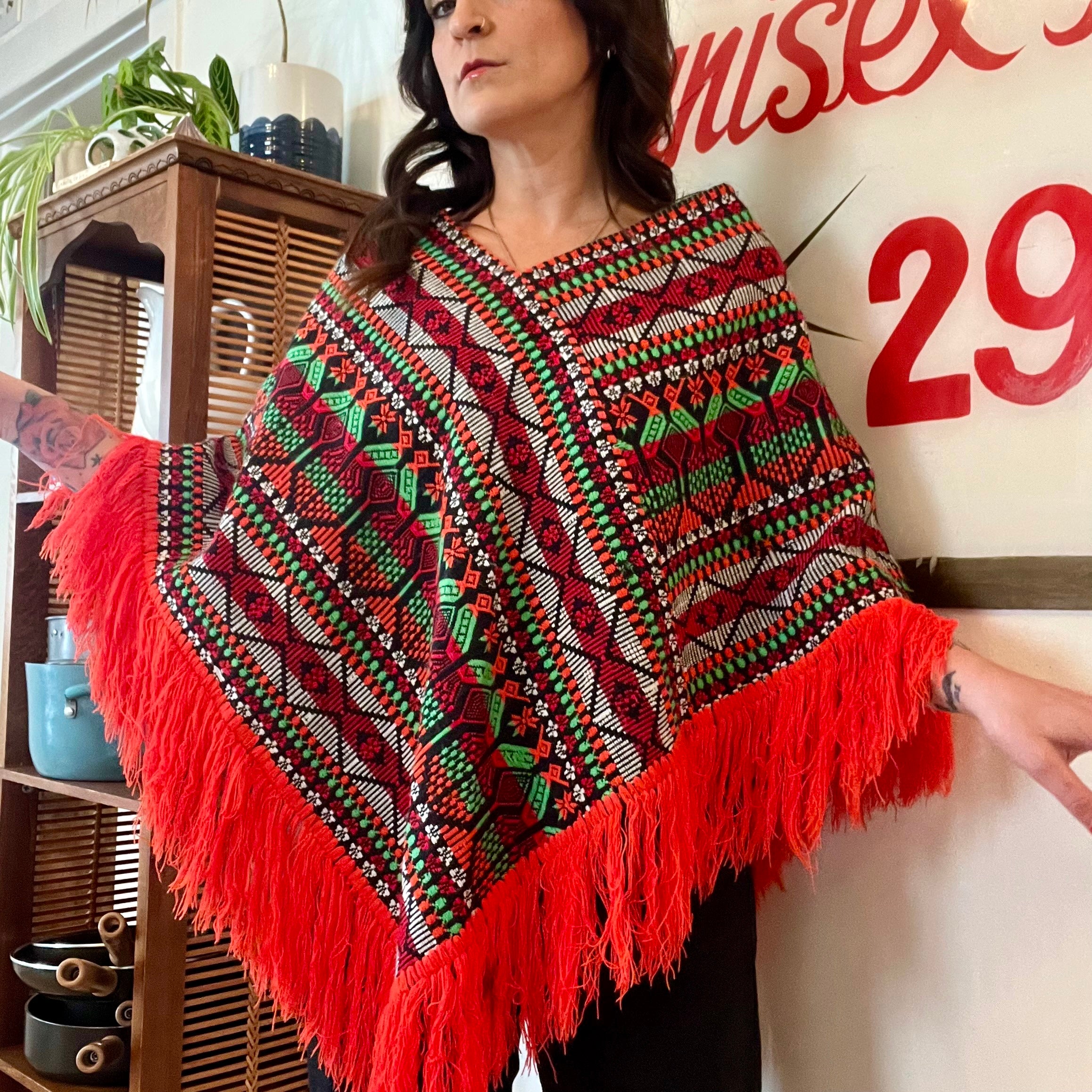Bright colorful poncho with fringe