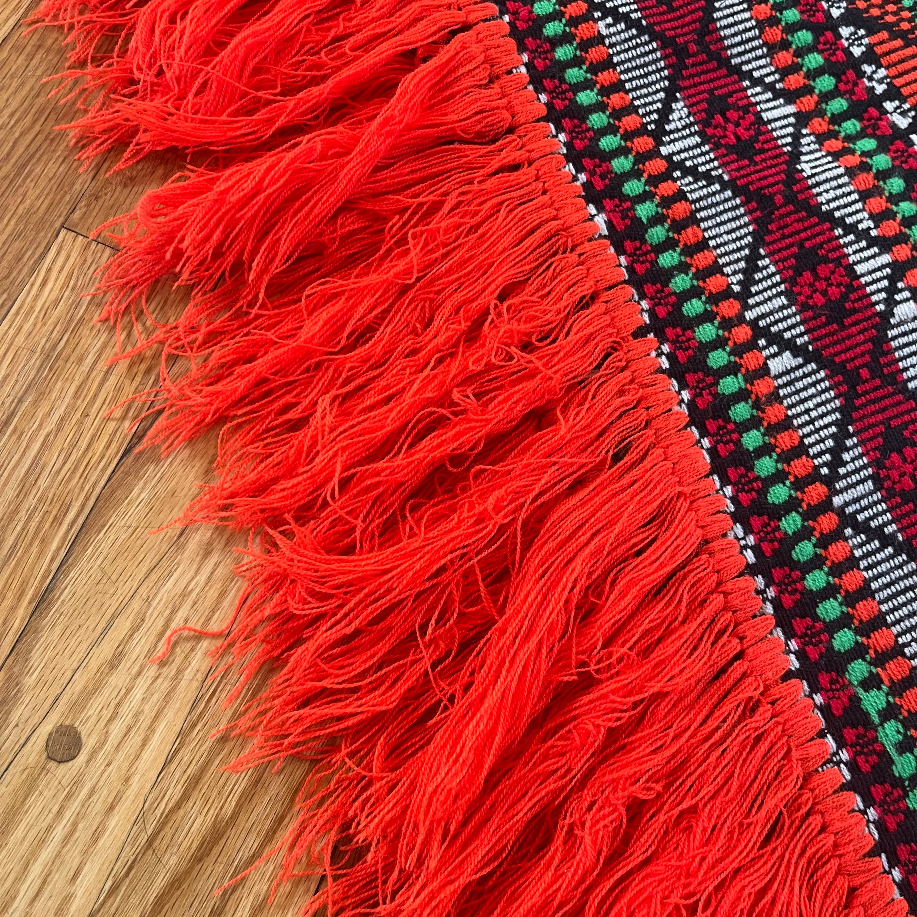 Bright colorful poncho with fringe