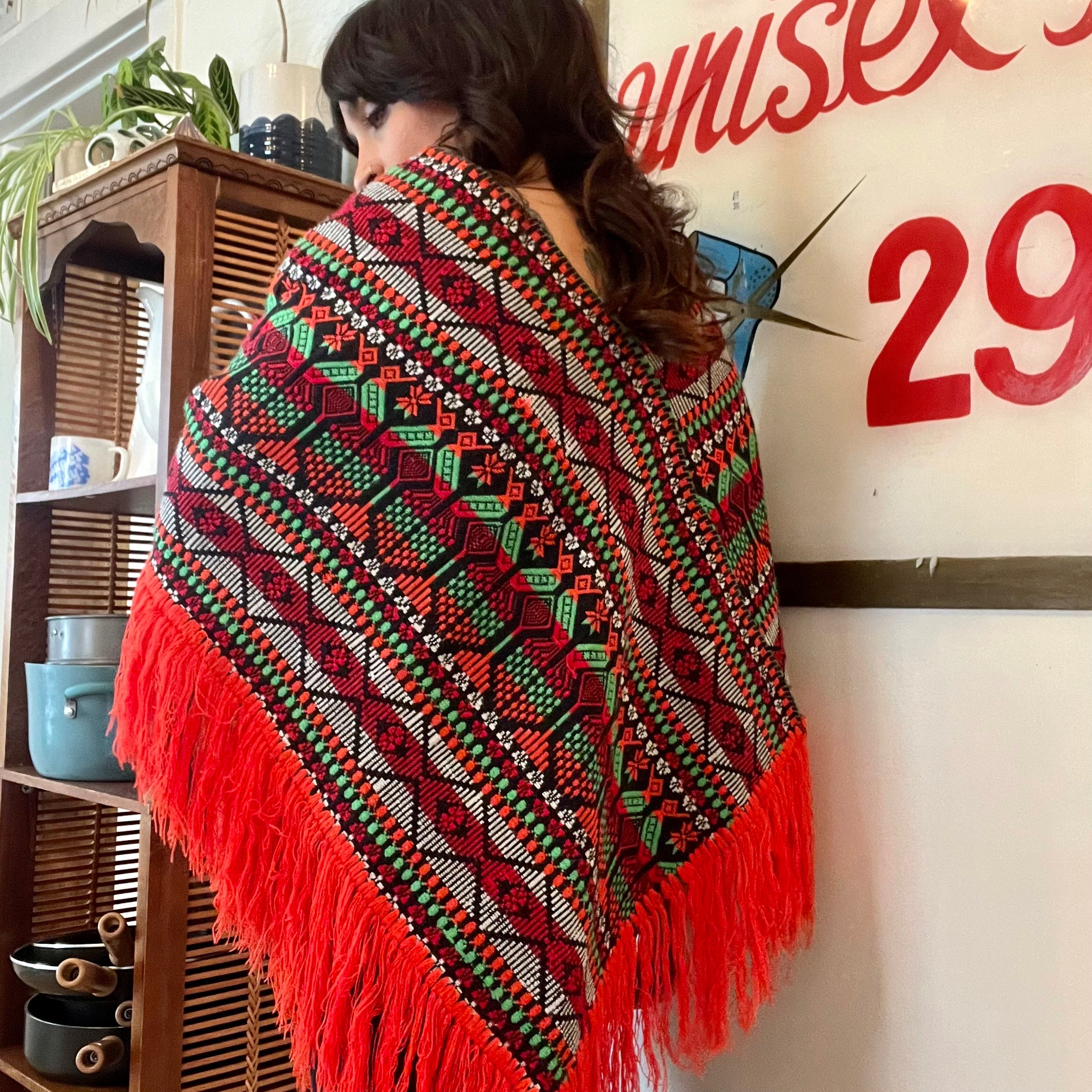 Bright colorful poncho with fringe