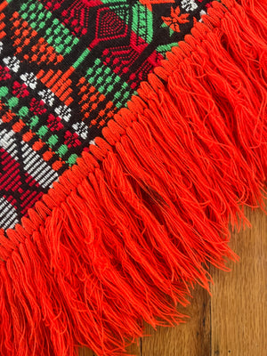 Bright colorful poncho with fringe 