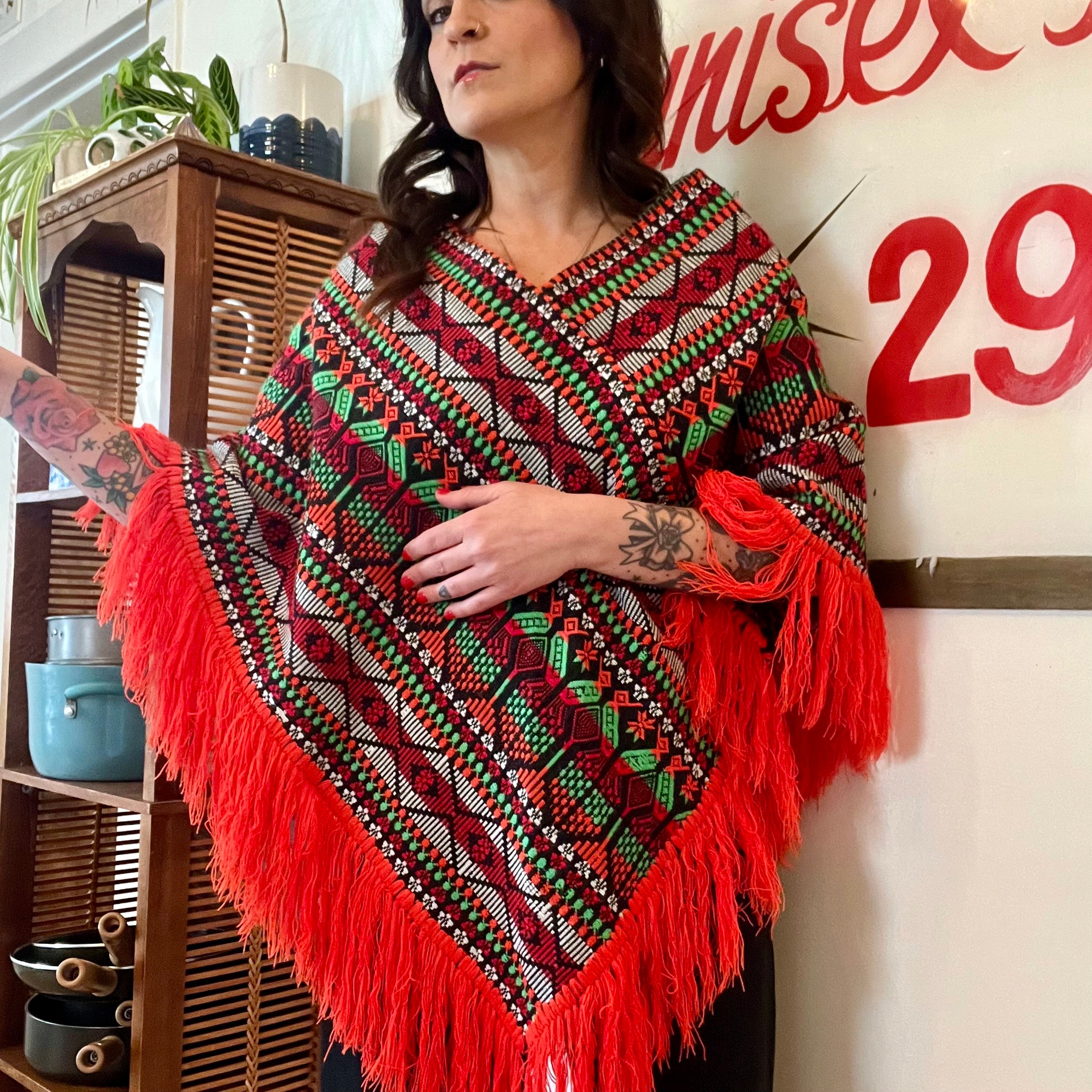 Bright colorful poncho with fringe